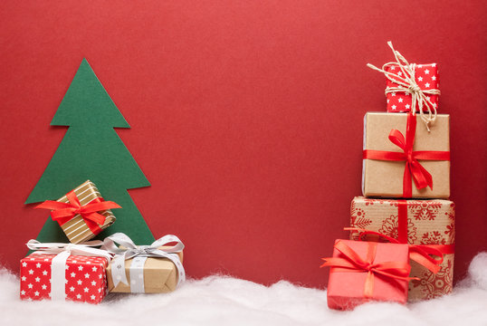 pile of christmas gifts red background with copyspace