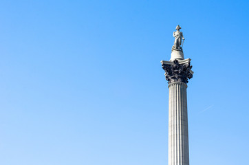 View of Nelson's Column against a blue sky with substantial text space