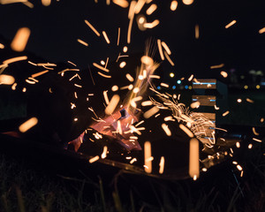 Campfire barbecue flames at night