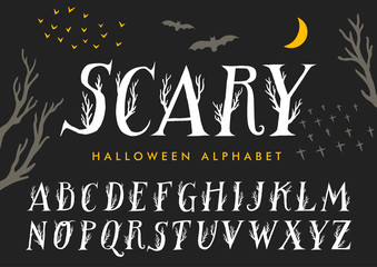Vector halloween alphabet. Uppercase letters decorated with tree branches.