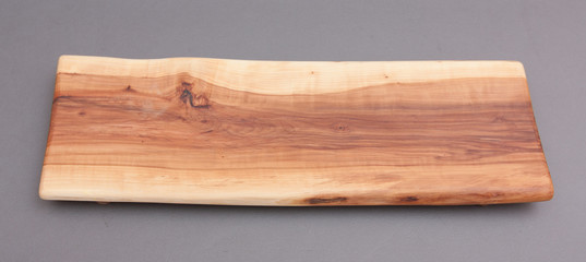 Ecological handmade wooden cutting board on grey background