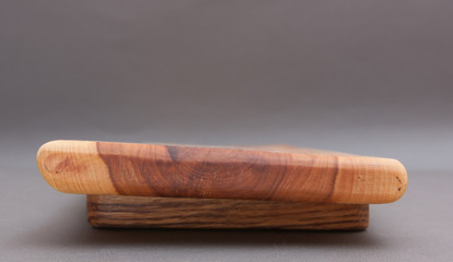 Ecological handmade wooden cutting board on grey background