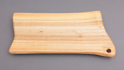 Ecological handmade wooden cutting board on grey background