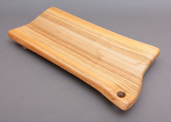 Ecological handmade wooden cutting board on grey background