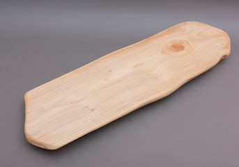 Ecological handmade wooden cutting board on grey background