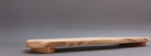 Ecological handmade wooden cutting board on grey background
