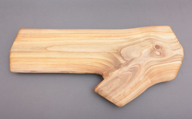 Ecological handmade wooden cutting board on grey background