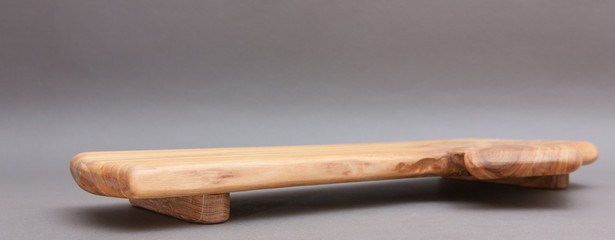 Ecological handmade wooden cutting board on grey background