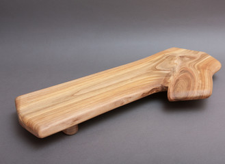 Ecological handmade wooden cutting board on grey background
