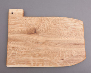 Ecological handmade wooden cutting board on grey background