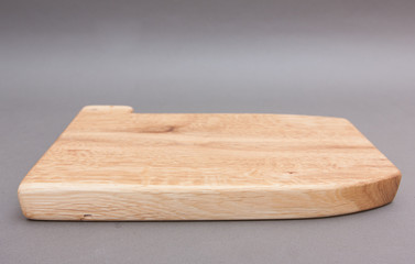 Ecological handmade wooden cutting board on grey background