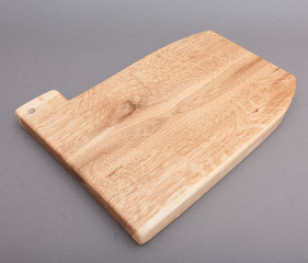 Ecological handmade wooden cutting board on grey background