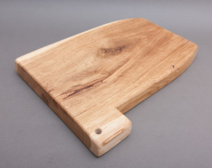 Ecological handmade wooden cutting board on grey background