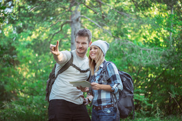 Naklejka na ściany i meble Hiking couple with map