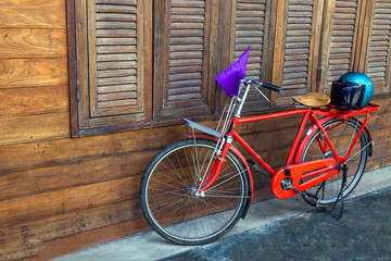 Red bike and wooden cover.