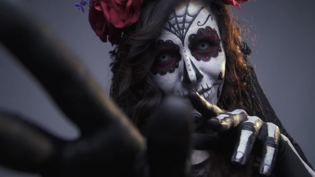 Mysterious girl skeleton smiles and beckons to herself, makeup for Halloween