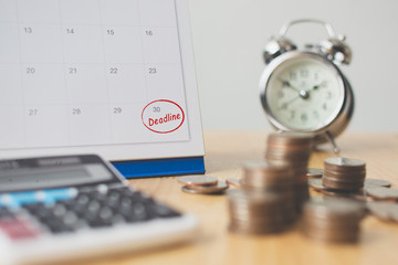 Tax payment season and finance debt collection deadline concept. Money coins stack, calendar, calculator and clock