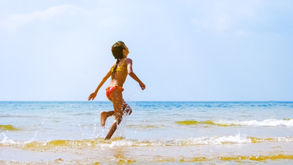 Summer fun beach woman splashing water. Panorama landscape of tropical ocean on travel holiday....