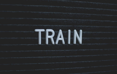 Word train written on the letter board. White letters on the black background. Business concept