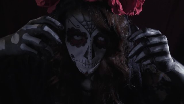 Mystical dead girl with a wreath of roses, make-up for Halloween