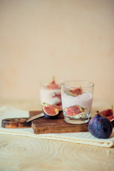 Autumn dessert in a jar with ripe figs and yogurt.