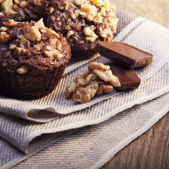 Homemade delicious chocolate Muffins with Walnut on wood backround
