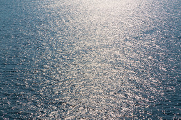 Fototapeta na wymiar Blue ocean sea with glowing sky reflection as background