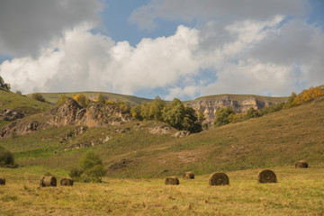 Beautiful landscape with straw bales in the autumn in mountains