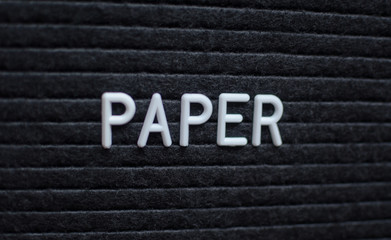 Hashtag word # paper written on the letter board. White letters on the black background.