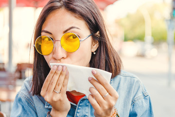 Asian woman wiping her mouth after a meal