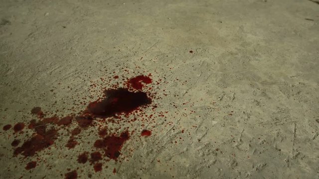 Blood dripping down into cement floor
