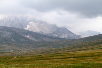 Fototapeta premium natural landscape photo of northern mountain landscape with heavy grey cloudy sky