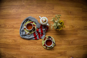 Tea ceremony, filled tea in service with wildflowers on the wood texture