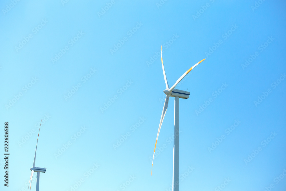 Wall mural electric wind mill turbines with blue sky background