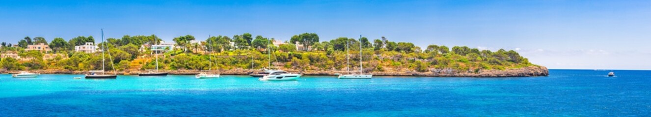Fototapeta na wymiar Boats at seaside of Majorca island, Spain Mediterranean Sea, panoramic view