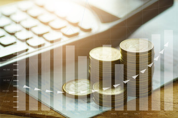 money coins stacked with calculator on book bank and capital finance with graph concept
