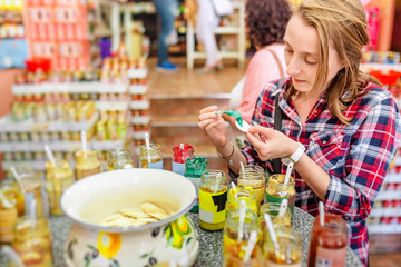 Portrait of a young model tasting various flavours of mustard