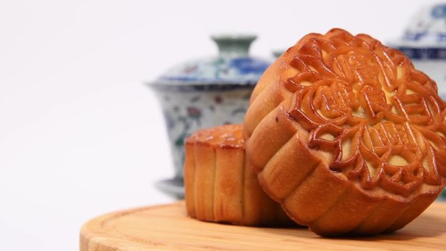Moon cakes Moon cakes rotating on white background,The Chinese character on the mooncake represent "Double white" in English