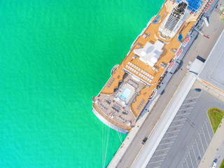 Aerial View by Drone of Cruise ship at harbour. Top view of beautiful large white liner in yacht...