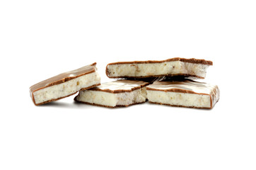 Chunks of chocolate with white stuffing isolated on white background. Chocolate bars with stuffing. Isolate. Side view.