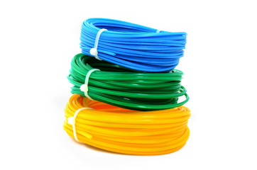 A stack of colored spools with a fishing line for the trimmer. Linear coil is yellow, blue, green for trimmer.