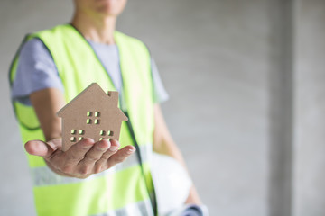 Real estate concept, engineer holding house model, inspection building