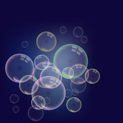Isolated colorful realistic shampoo bubbles with a reflection of a transparent dark background.