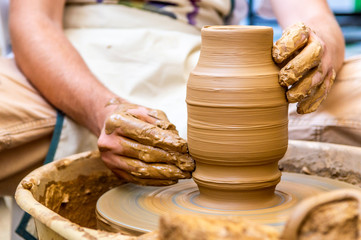 Pottery artist making clay pot in a workshop