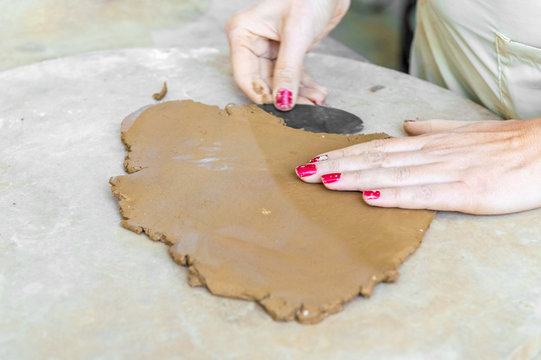 Female hands working on clay