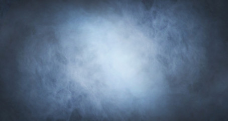 Abstract smoke texture over black background. Fog in the darkness.