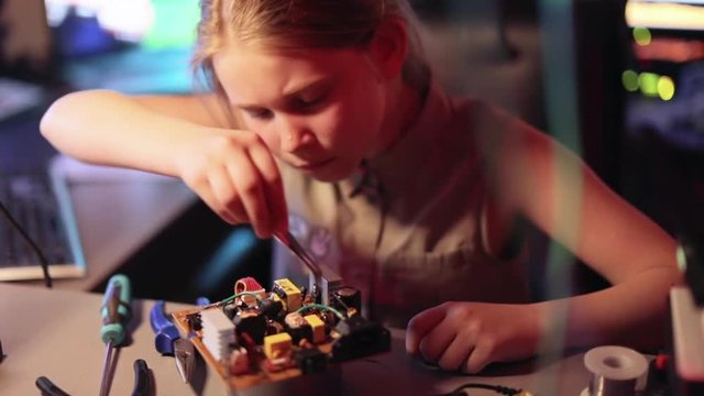 Young Girl with Interest Invents New Technologies in the Home Lab. Slow motion