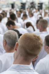 Meeting of people in white clothes. Vertical photo