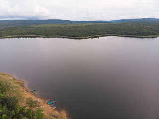 Drone shot Aerial view landscape scenic of big river reservoir with nature forest and mountains in tropical land
