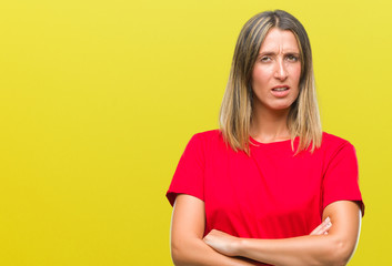 Young beautiful woman over isolated background skeptic and nervous, disapproving expression on face with crossed arms. Negative person.